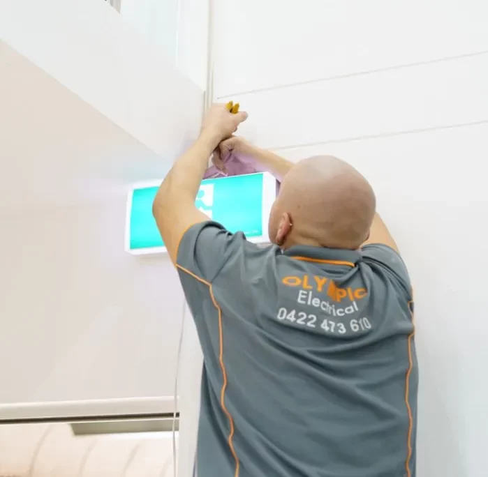 Maroubra electrician installing an emergency exit light.