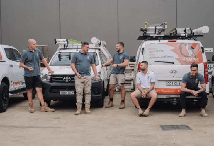 Electrician Sutherland Shire team standing by work vehicles at Olympic Electrical.